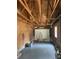 View of the spacious garage showing unfinished walls, a garage door, and a painted floor at 2 Clarksville Ln, Goose Creek, SC 29445