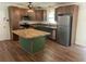 A bright kitchen featuring an island with butcher block countertop and stainless appliances at 2 Clarksville Ln, Goose Creek, SC 29445