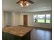 Well-lit kitchen with a window and view into a living space, ceiling fan, and recessed lights at 2 Clarksville Ln, Goose Creek, SC 29445