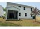 Exterior view of a two-story home with a screened porch, vinyl siding, and a well-maintained lawn at 2018 Quiet Ibis Rd, Hanahan, SC 29410