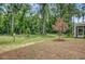 Landscaped backyard featuring mature trees and open green space at 2018 Quiet Ibis Rd, Hanahan, SC 29410