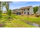 Picturesque backyard featuring a stream, lush grass, and a charming screen porch at 2018 Quiet Ibis Rd, Hanahan, SC 29410