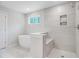 Bright bathroom with tiled shower, soaking tub, and modern finishes at 2018 Quiet Ibis Rd, Hanahan, SC 29410