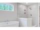 Modern bathroom featuring a soaking tub, tiled shower, and a large window at 2018 Quiet Ibis Rd, Hanahan, SC 29410