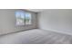 Sunlit bedroom features carpet and large windows with a view of the neighborhood at 2018 Quiet Ibis Rd, Hanahan, SC 29410