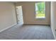 Cozy bedroom featuring plush gray carpet and a window with a view of the green outdoors at 2018 Quiet Ibis Rd, Hanahan, SC 29410