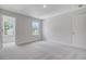 Light-filled bedroom featuring soft carpet, a large window, and a closet at 2018 Quiet Ibis Rd, Hanahan, SC 29410