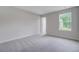 Bright bedroom featuring soft carpet and a large window overlooking the yard at 2018 Quiet Ibis Rd, Hanahan, SC 29410