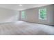 Bedroom with two windows and a door to the en suite bathroom at 2018 Quiet Ibis Rd, Hanahan, SC 29410