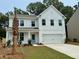 Charming two-story home with white siding, an attached two-car garage, and a neatly manicured lawn at 2018 Quiet Ibis Rd, Hanahan, SC 29410