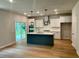 Spacious kitchen with a large island, stainless steel appliances, sleek white cabinets, and elegant pendant lights at 2018 Quiet Ibis Rd, Hanahan, SC 29410