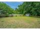 This spacious backyard has a charming shed, a well-maintained lawn, and a wooden fence at 2031 Thornhill Dr, Summerville, SC 29485