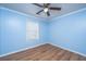 Bedroom with blue walls, hardwood flooring, a window, ceiling fan, and white trim at 2031 Thornhill Dr, Summerville, SC 29485