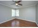 This bedroom features hardwood floors, a ceiling fan, and ample natural light from the corner windows at 2031 Thornhill Dr, Summerville, SC 29485