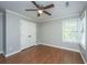 The bedroom features a ceiling fan, closet, hardwood floors, and a window offering natural light at 2031 Thornhill Dr, Summerville, SC 29485