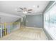 The bonus room features great natural light and a staircase with a neutral carpet, ready for personal touches at 2031 Thornhill Dr, Summerville, SC 29485