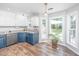 Bright kitchen features stainless steel appliances, white cabinetry and natural light from three large windows at 2031 Thornhill Dr, Summerville, SC 29485