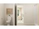 Bathroom featuring toilet, shower, and view into bedroom with large window at 205 Agrarian Ave, Summerville, SC 29485