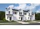 Charming exterior view of new build townhomes with light blue siding and a one car garage at 205 Agrarian Ave, Summerville, SC 29485