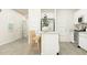 Bright kitchen featuring white cabinetry, stainless steel appliances, island with seating, and hardwood flooring at 205 Agrarian Ave, Summerville, SC 29485