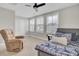 Bright bedroom featuring plush carpeting, a ceiling fan, and a comfortable recliner chair at 208 Kirkland St, Goose Creek, SC 29445