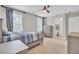Bedroom with a neutral palette, carpet flooring, ceiling fan, and attached bathroom at 208 Kirkland St, Goose Creek, SC 29445