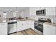 Well-lit kitchen with stainless steel microwave and oven, ample counter space, and white cabinets at 208 Kirkland St, Goose Creek, SC 29445