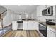 Bright kitchen with stainless steel appliances, granite countertops, and an open view to the dining area at 208 Kirkland St, Goose Creek, SC 29445