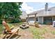 Backyard with a firepit, wooden swing, and chairs, perfect for entertaining at 209 Apache Dr, Summerville, SC 29483