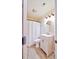 Bright bathroom with a white vanity, decorative mirror, and a shower with a white curtain at 209 Apache Dr, Summerville, SC 29483