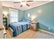 Cozy bedroom featuring blue walls, wood-look floors, and a comfortable bed with a blue patterned comforter at 209 Apache Dr, Summerville, SC 29483