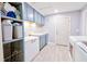 Laundry room with blue cabinets, white counters, modern appliances, and lots of storage at 209 Apache Dr, Summerville, SC 29483