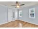 Cozy bedroom features hardwood floors, natural light, and a ceiling fan at 21 Rivers Point Row # 17G, Charleston, SC 29412