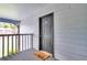 Apartment entryway with a gray door, welcome mat, and view of lush greenery at 21 Rivers Point Row # 17G, Charleston, SC 29412