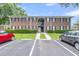 Brick apartment building exterior with parking and landscaping under a blue sky at 21 Rivers Point Row # 17G, Charleston, SC 29412