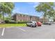 Apartment building exterior featuring ample parking, landscaping, and architectural details at 21 Rivers Point Row # 17G, Charleston, SC 29412