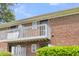 Brick building exterior with white balcony and well-maintained green shrubbery at 21 Rivers Point Row # 17G, Charleston, SC 29412