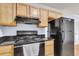 Bright kitchen showcasing wooden cabinets and modern black appliances at 21 Rivers Point Row # 17G, Charleston, SC 29412