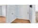 Neutral laundry room with hardwood floors, white door, and wire shelving at 21 Rivers Point Row # 17G, Charleston, SC 29412