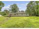 A lush green backyard featuring mature trees and the back of the house at 2202 Sc-61, Ridgeville, SC 29472