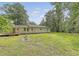 Expansive backyard featuring a partially covered deck and lush greenery at 2202 Sc-61, Ridgeville, SC 29472