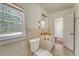 An outdated bathroom featuring a window, toilet, and sink with drawers at 2202 Sc-61, Ridgeville, SC 29472