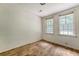 Bright bedroom featuring laminate floors and two windows, offering natural light at 2202 Sc-61, Ridgeville, SC 29472