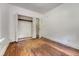A simple bedroom featuring hardwood floors, a window, closet, and adjacent room at 2202 Sc-61, Ridgeville, SC 29472