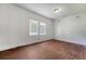 A light filled empty bedroom with natural lighting and original hardwood floors at 2202 Sc-61, Ridgeville, SC 29472