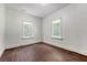 An empty bedroom featuring two windows and original hardwood floors at 2202 Sc-61, Ridgeville, SC 29472