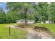 Quaint single-story house surrounded by a lush green lawn and a large shade tree at 2202 Sc-61, Ridgeville, SC 29472