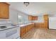 Well-lit kitchen featuring wooden cabinetry, laminate floors, and a white appliance set at 2202 Sc-61, Ridgeville, SC 29472