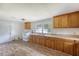 Bright kitchen with wooden cabinetry, laminate floors, and a white appliance set at 2202 Sc-61, Ridgeville, SC 29472