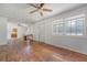 Spacious living room featuring hardwood floors, ceiling fan, and an entrance leading into the kitchen at 2202 Sc-61, Ridgeville, SC 29472